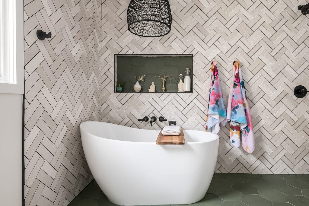 Stand alone bathtub with modern herringbone tile work in Chicago bathroom renovation