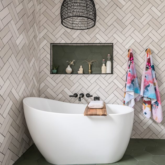 Stand alone bathtub with modern herringbone tile work in Chicago bathroom renovation