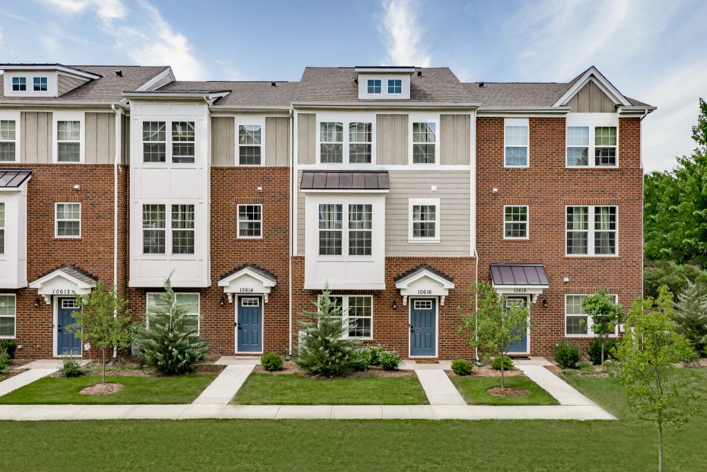 Exterior photo of townhomes in springtime
