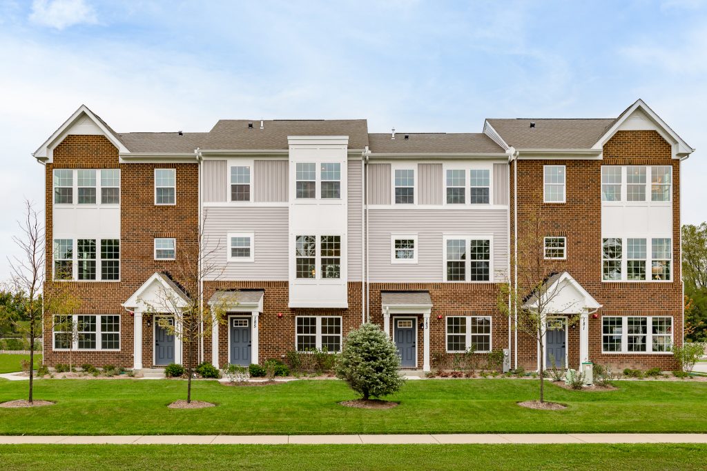 Exterior photo of townhomes in springtime
