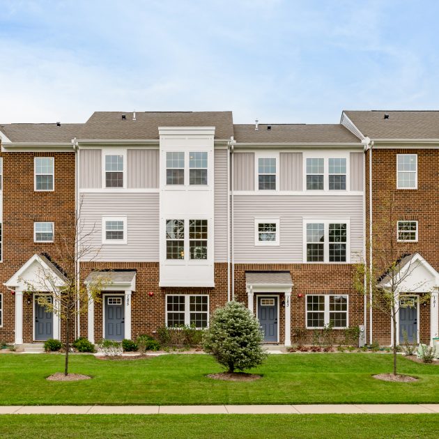 Exterior photo of townhomes in springtime