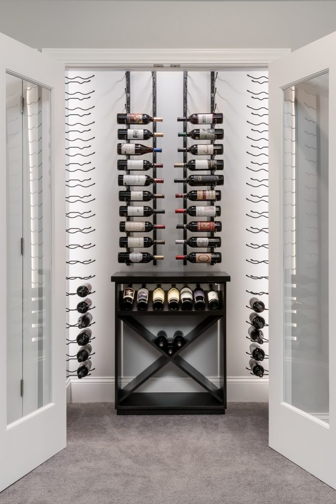Small custom wine cellar built into walk in closet
