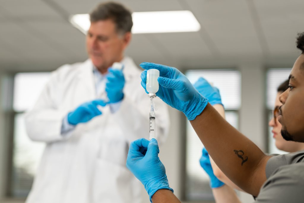 Concordia University Chicago BSN Program, Nursing Simulation Lab with students and instructor, filling syringe, Educational and Healthcare Photos