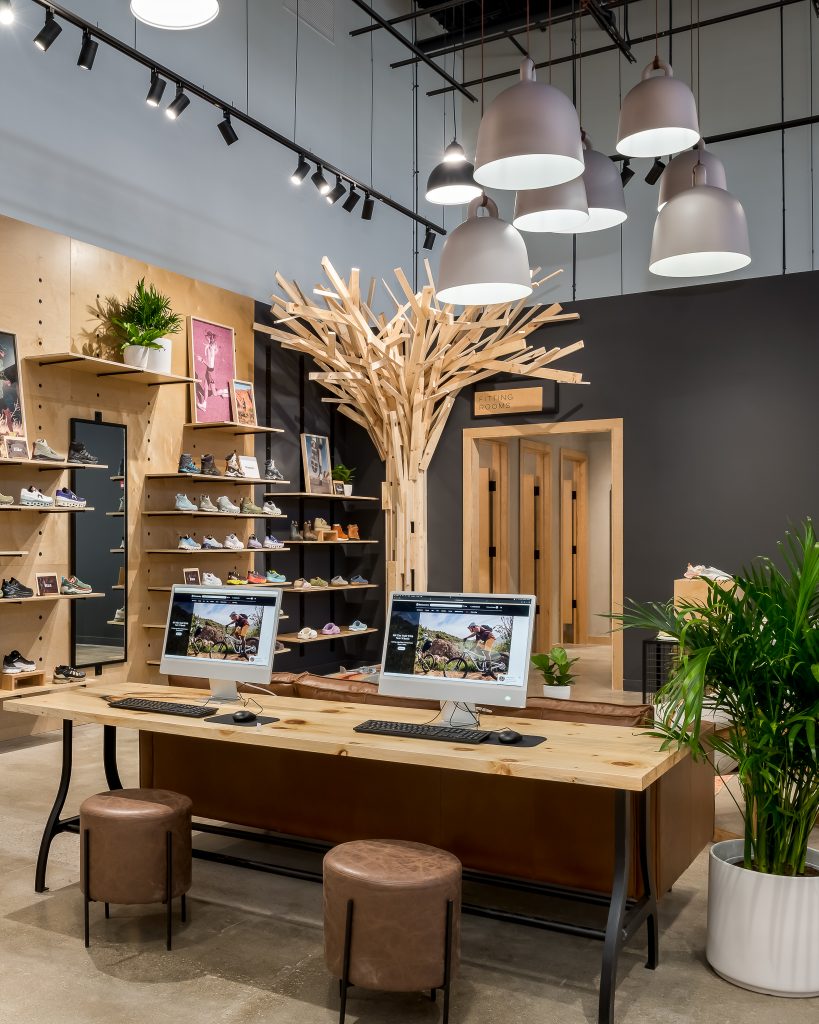 Fitting rooms and shoe sales with desktop computers to search for product.