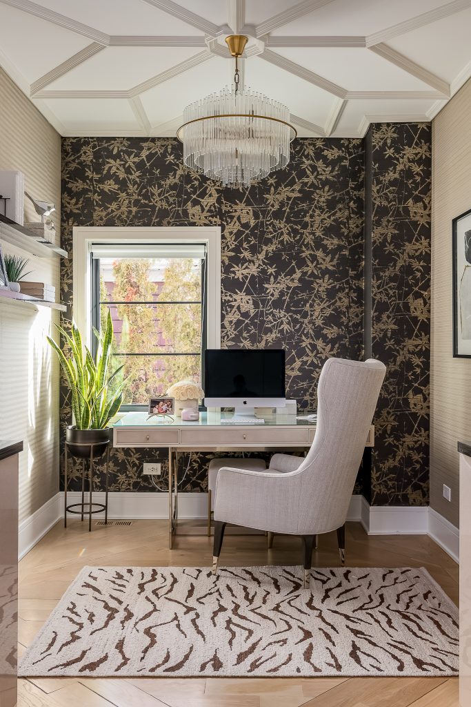 Dramatic home office with bold wallpaper and ceiling. Zebra print rug and crystal chandelier.
