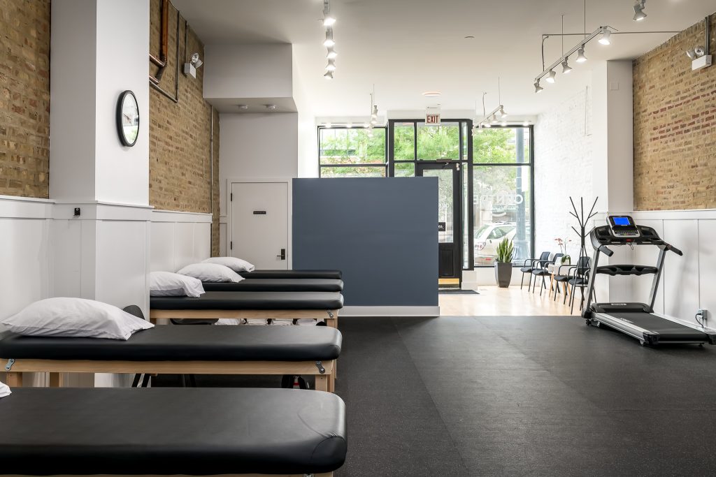 Beds and treadmill in physical therapy office
