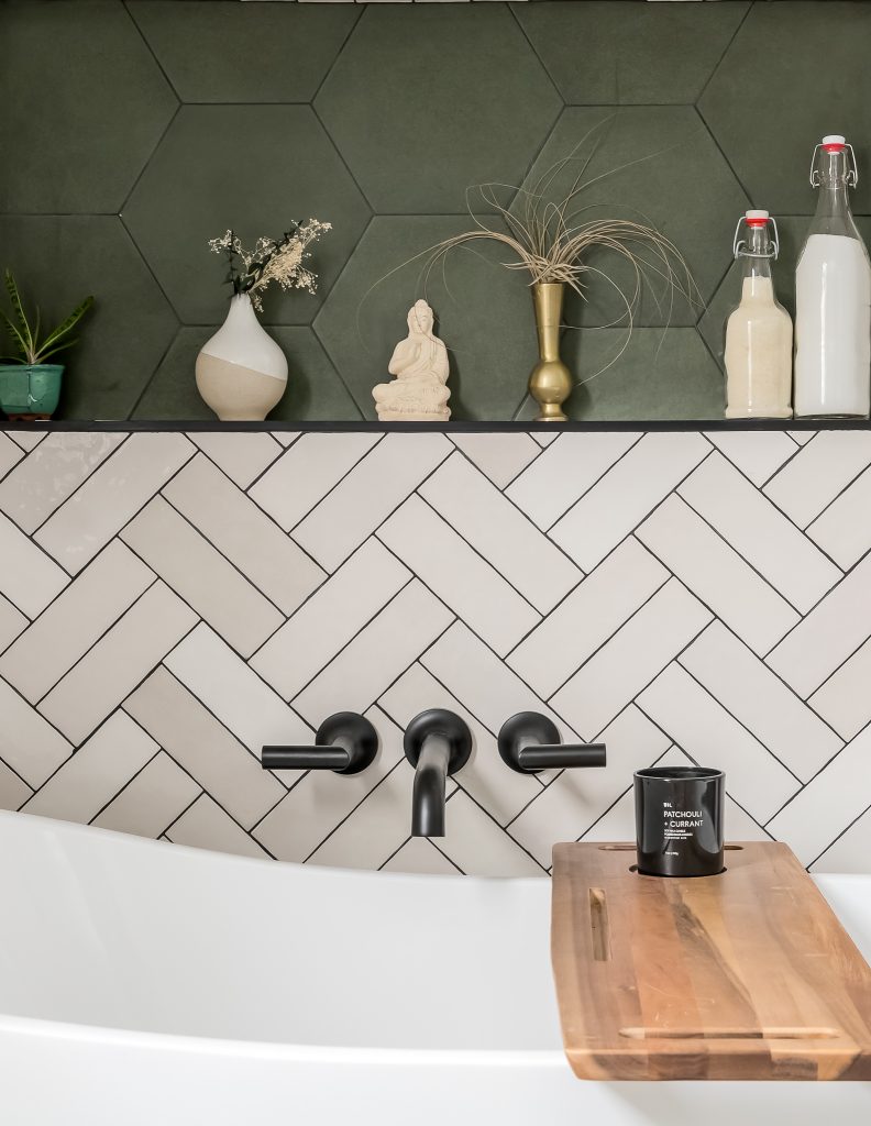 Detail of matte black fixtures on stand alone tub in modern bathroom renovation