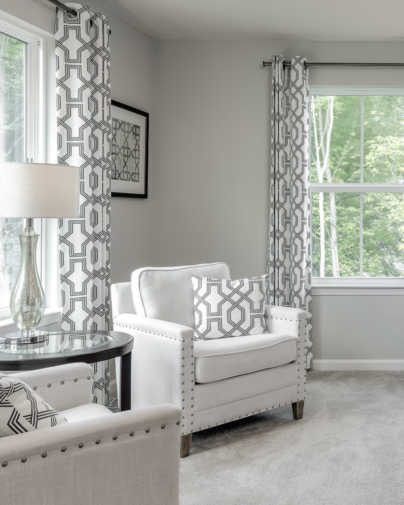 Detail of style seating area in primary bedroom of model home