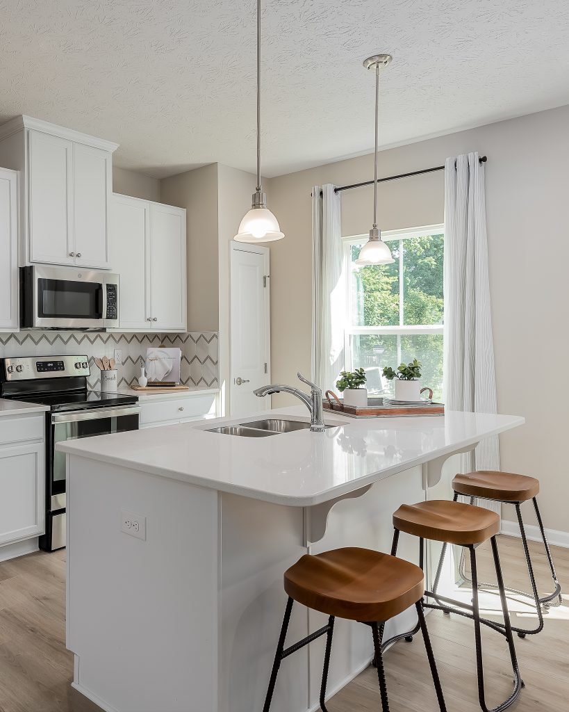 White kitchen with modern wooden stools at kitchen island