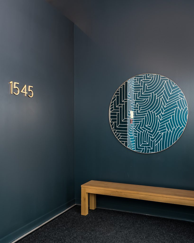 Bold and modern apartment lobby with blue wallpaper