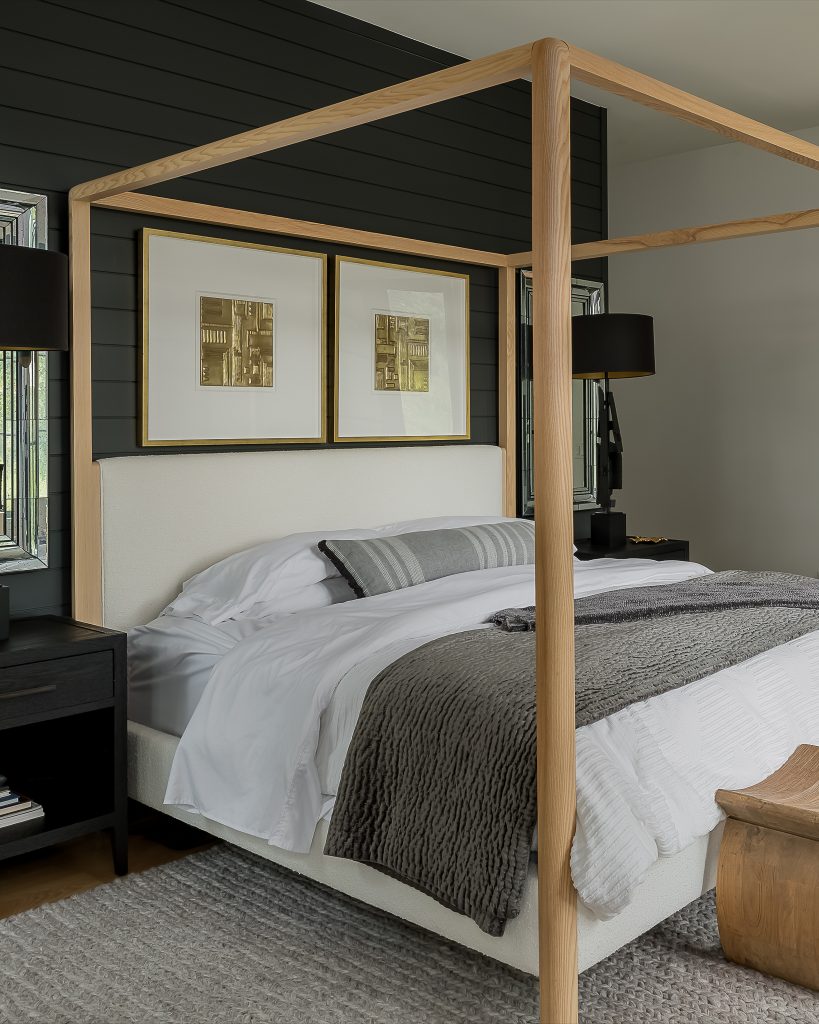 Primary bedroom with moody interior and four poster bed
