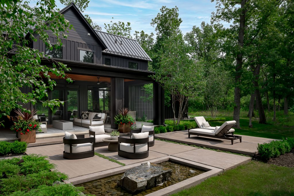 Beautiful custom backyard entertaining space of modern black farmhouse