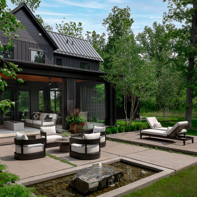 Beautiful custom backyard entertaining space of modern black farmhouse