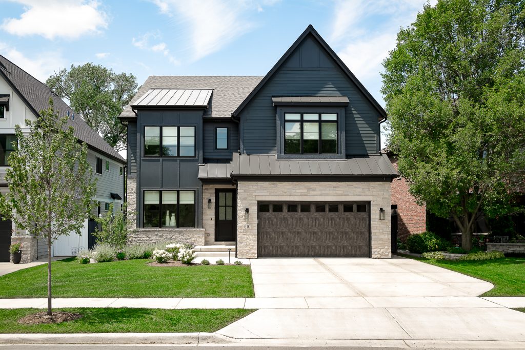 Contemporary Home Exterior with Black Siding and Beige Brick Accents