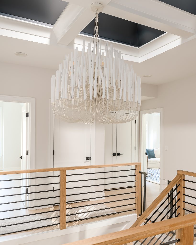 Modern chandelier over contemporary staircase.