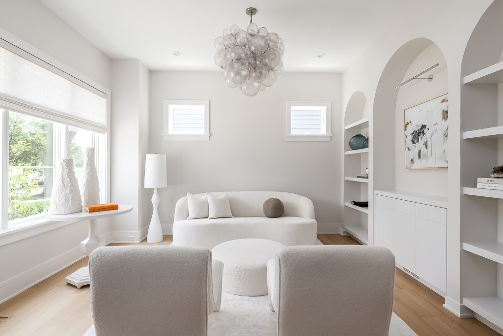 Modern all-white living room with custom white couch and blown glass chandelier