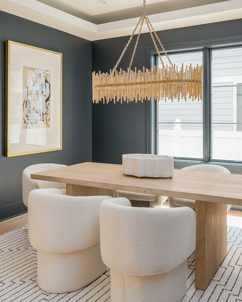 Contemporary Dining room with moody interior and statement chandelier