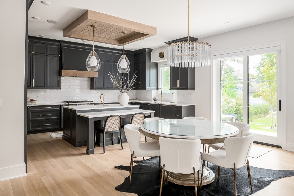 Transitional kitchen and dining area with dark cabinets and walnut accents