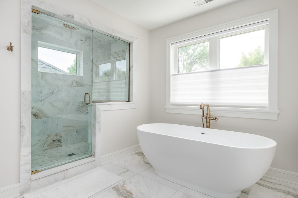 Bright and soothing modern bathroom design with stand alone tub and walk in shower