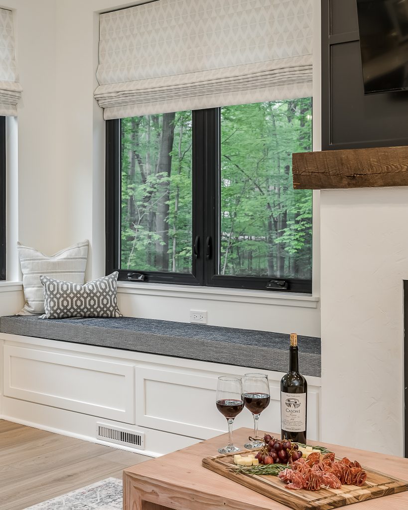 a cozy window seat in a rustic-inspired luxury rental home