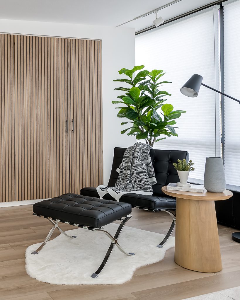 Modern reading chair in corner of bedroom.