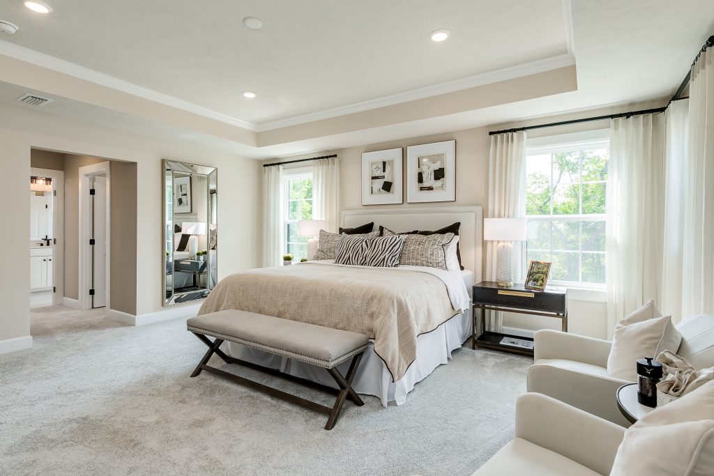 Traditional primary bedroom suite in Heartland Homes model.