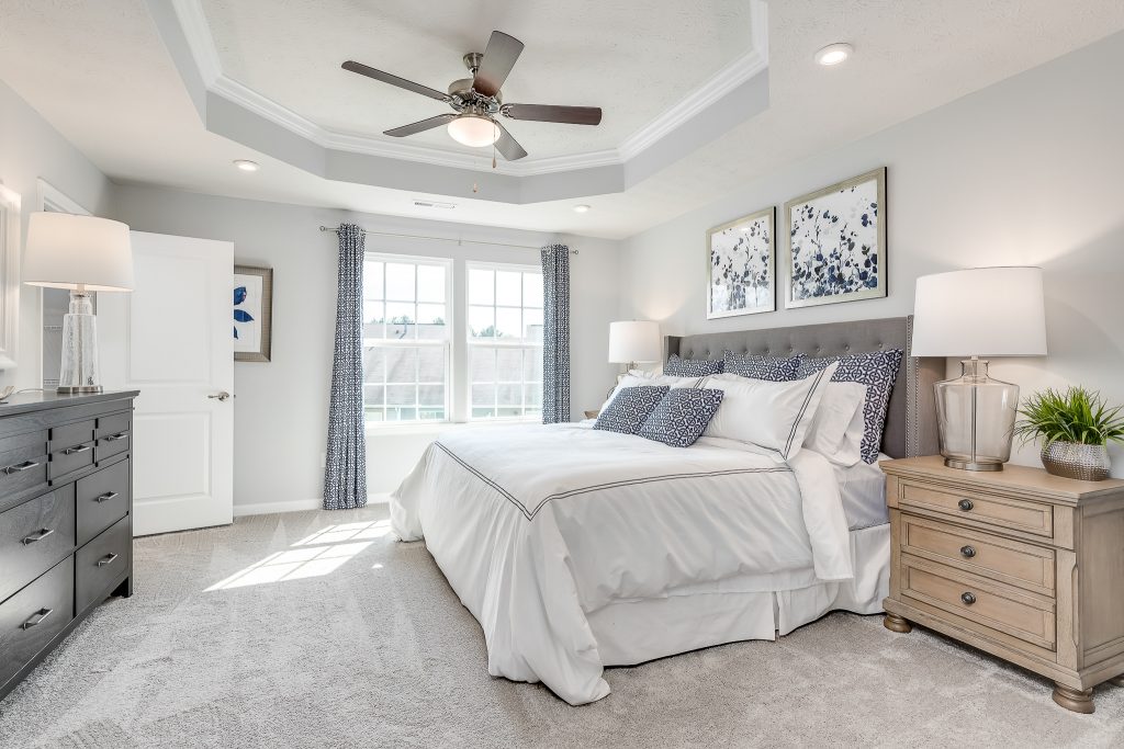 Formal primary bedroom with vaulted ceilings